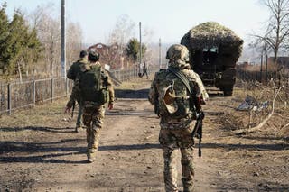 Russian soldiers patrol an area in the Kursk region